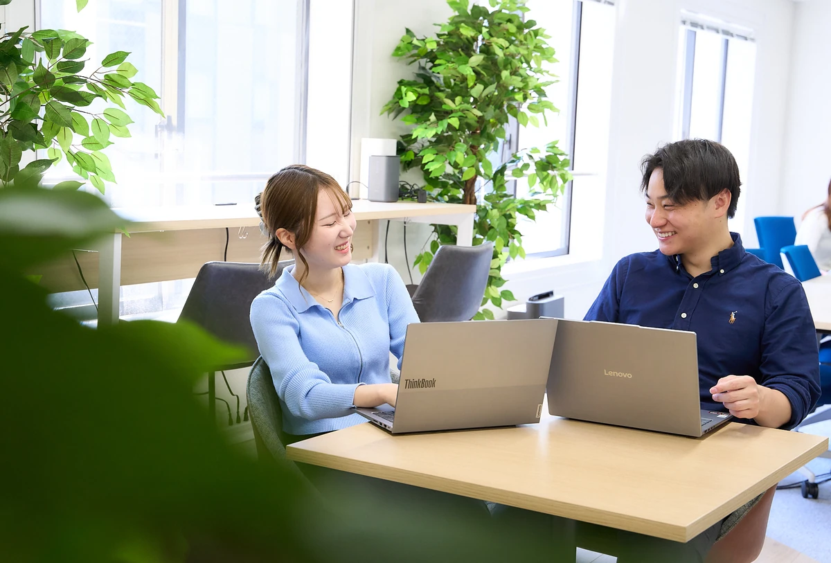 テーブルで向かい合って話す社員